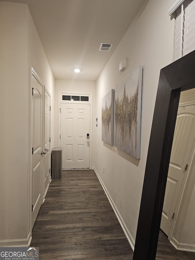 hallway with dark hardwood / wood-style flooring