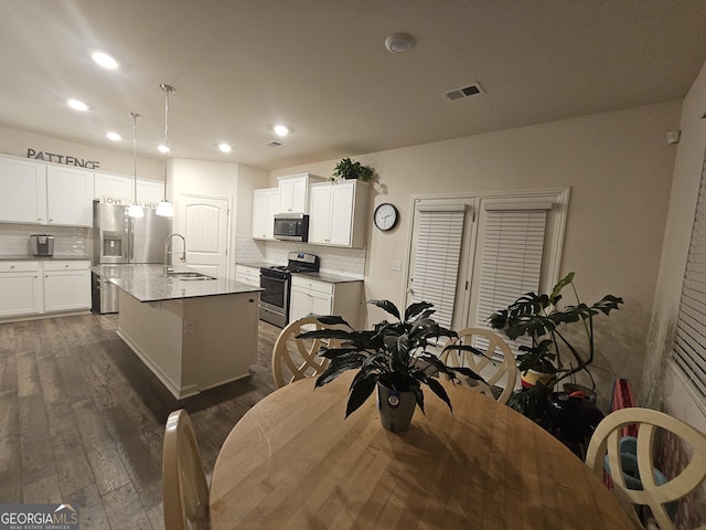 dining space featuring dark wood-type flooring and sink