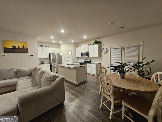 living room featuring dark hardwood / wood-style flooring and sink