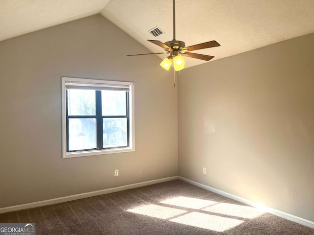 carpeted spare room featuring lofted ceiling, a textured ceiling, and ceiling fan