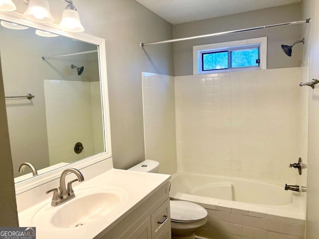 full bathroom with tiled shower / bath combo, vanity, and toilet