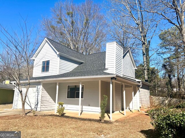 exterior space with a porch and a garage