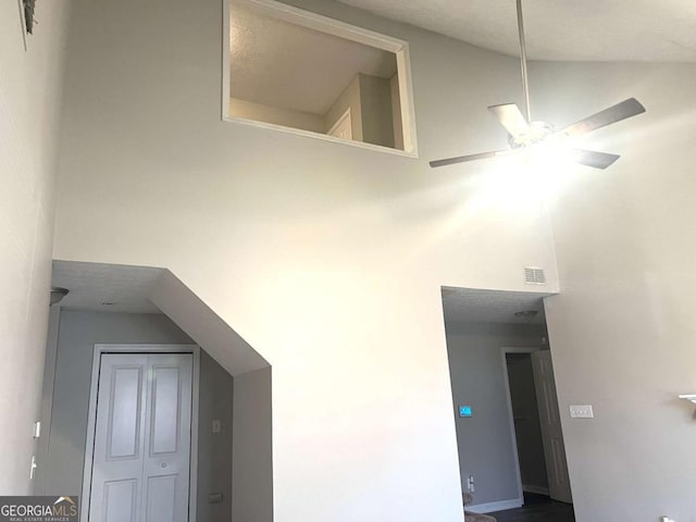 interior space featuring ceiling fan and high vaulted ceiling