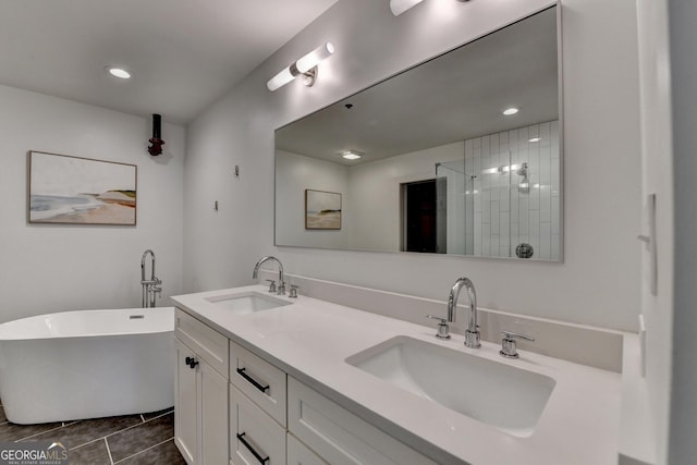 bathroom with vanity, a washtub, and tile patterned floors