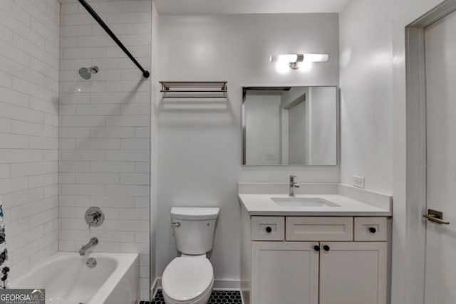 full bathroom featuring tiled shower / bath combo, vanity, and toilet