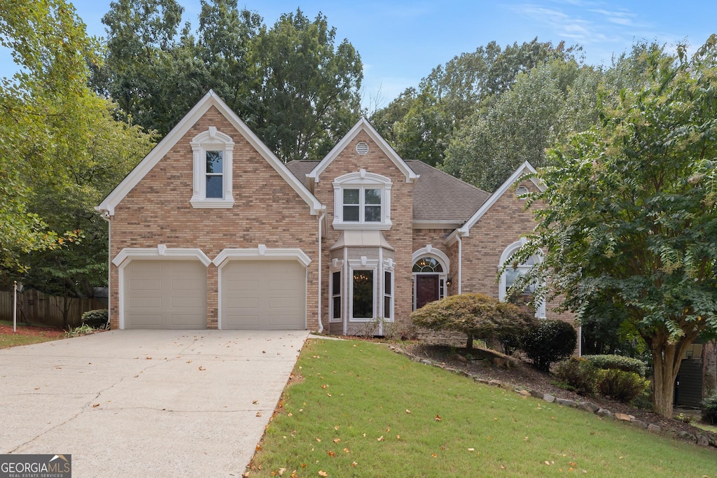 view of front of house with a garage and a front yard