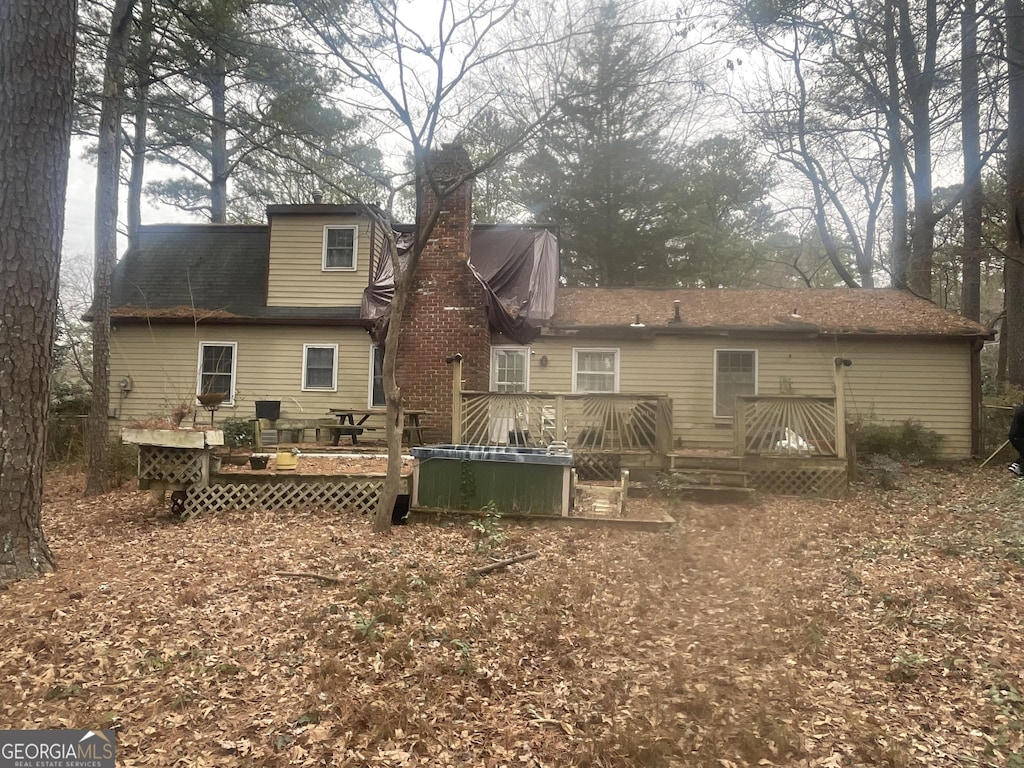 back of property featuring a deck