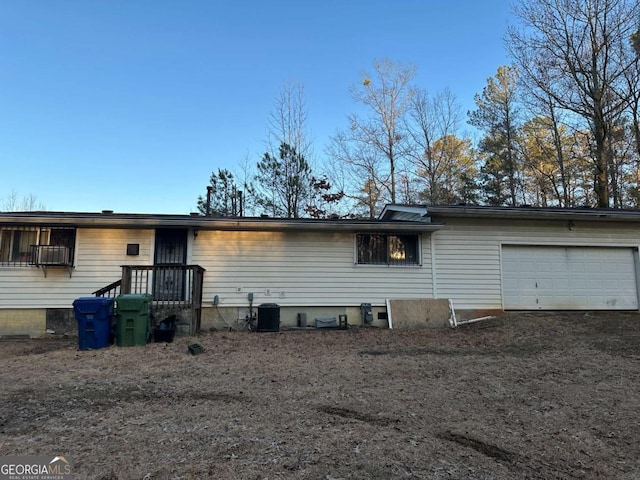 view of front facade with a garage and central AC