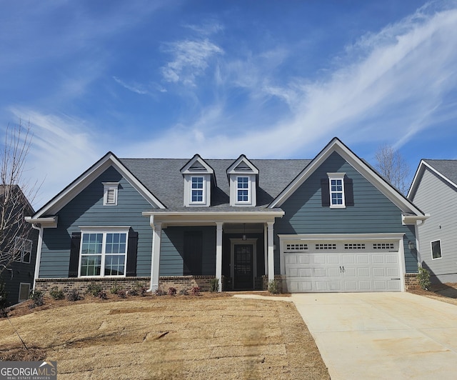 view of front of house featuring covered porch, concrete driveway, brick siding, and a garage