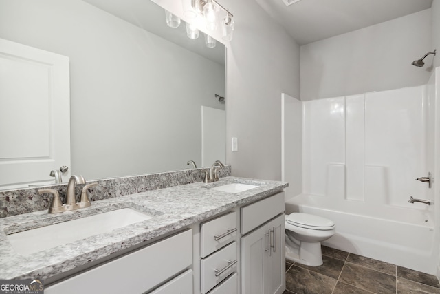 full bath with toilet, shower / tub combination, double vanity, and a sink