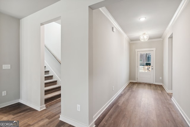 doorway to outside featuring stairway, crown molding, baseboards, and wood finished floors