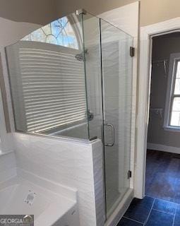 bathroom featuring plenty of natural light, separate shower and tub, and tile patterned flooring