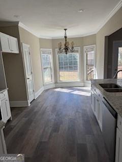 kitchen with sink, white cabinets, dark hardwood / wood-style flooring, ornamental molding, and stainless steel dishwasher