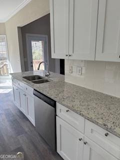 kitchen with white cabinetry, dishwasher, light stone countertops, and sink