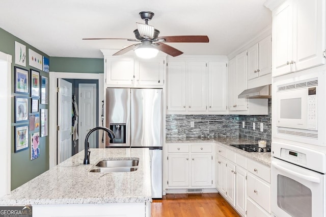 kitchen with white cabinetry, sink, white appliances, and wall chimney exhaust hood