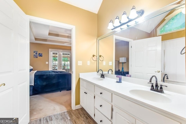 bathroom with vanity, hardwood / wood-style floors, crown molding, and french doors