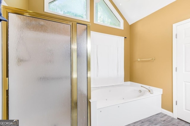 bathroom featuring vaulted ceiling, wood-type flooring, and shower with separate bathtub