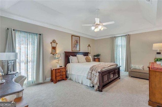 bedroom featuring multiple windows, crown molding, light colored carpet, and ceiling fan