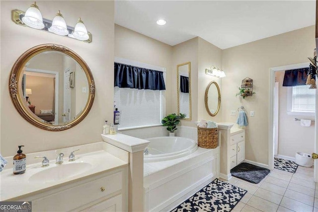 bathroom with tile patterned flooring, a bathing tub, and vanity