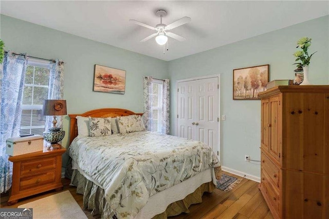 bedroom featuring hardwood / wood-style floors, ceiling fan, and a closet