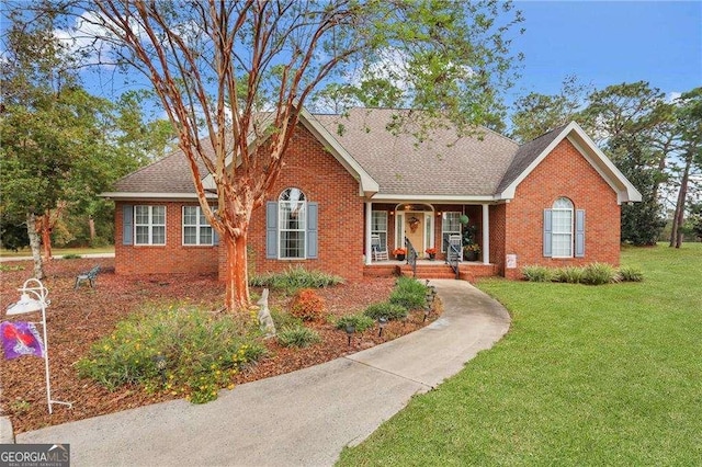 single story home with a porch and a front yard