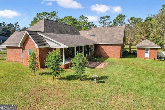 back of property with a lawn and a shed