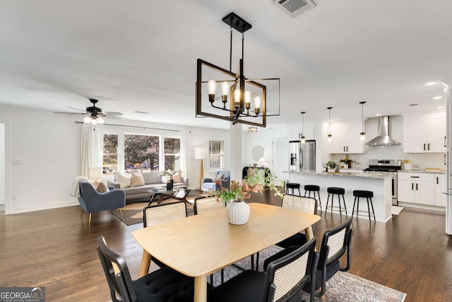 dining space with ceiling fan and dark hardwood / wood-style floors