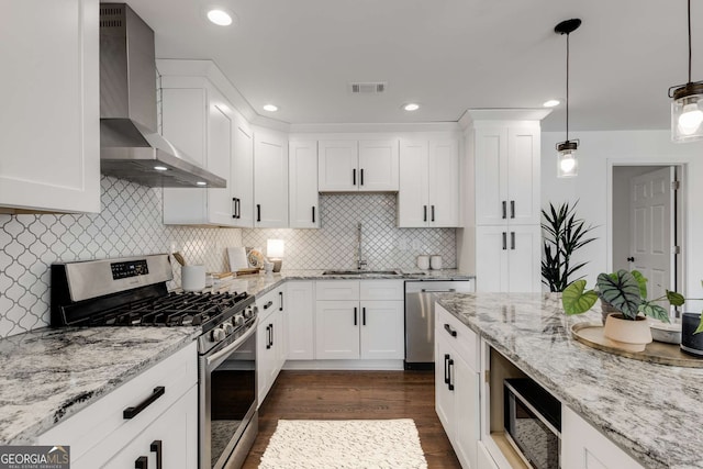 kitchen with white cabinetry, sink, wall chimney exhaust hood, and appliances with stainless steel finishes