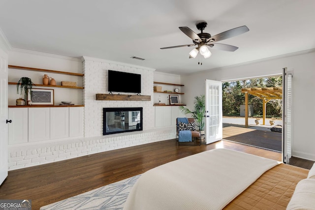 bedroom featuring access to outside, ornamental molding, ceiling fan, a fireplace, and hardwood / wood-style floors