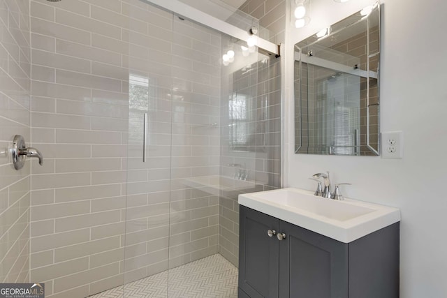 bathroom featuring vanity and a shower with shower door