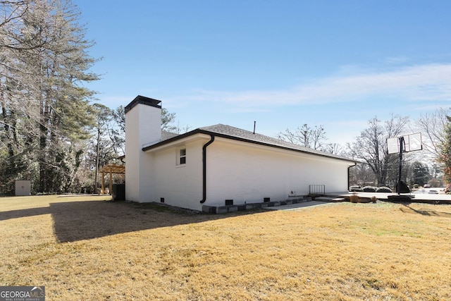 view of home's exterior with a lawn