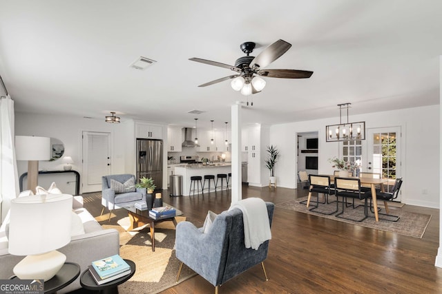 living room with ceiling fan and dark hardwood / wood-style flooring