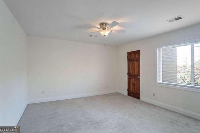 spare room featuring ceiling fan and light colored carpet