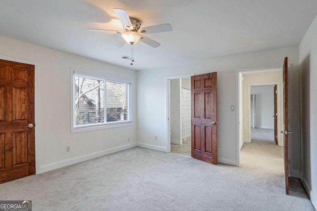 unfurnished bedroom featuring light colored carpet and ceiling fan