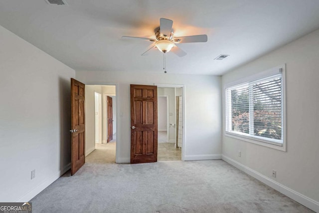 unfurnished bedroom featuring light colored carpet and ceiling fan