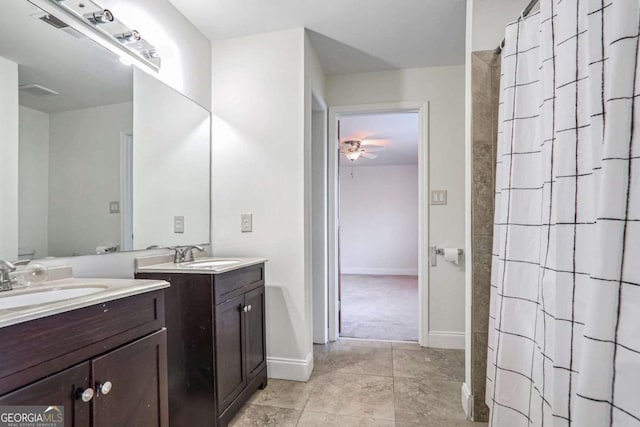 bathroom with vanity, ceiling fan, and walk in shower