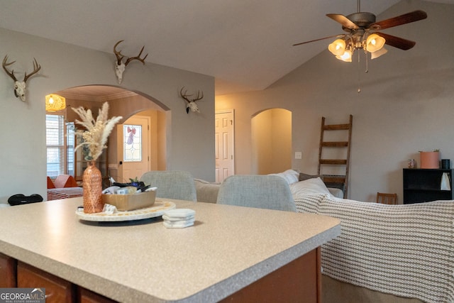 kitchen featuring ornamental molding, lofted ceiling, and ceiling fan