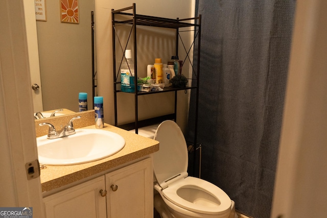 bathroom featuring vanity, toilet, and a shower with shower curtain