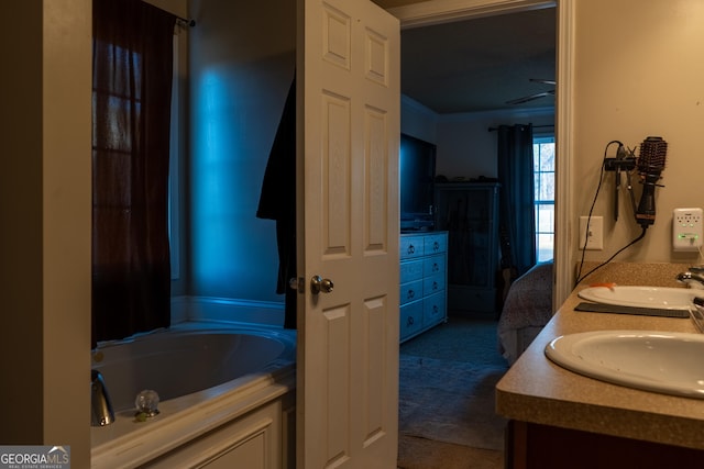 bathroom with vanity and a bath