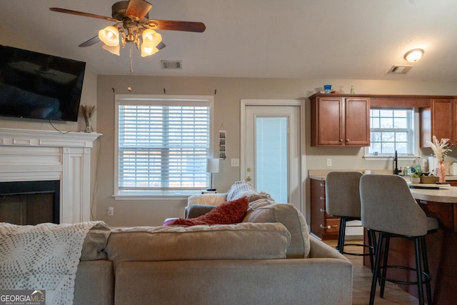 living room with hardwood / wood-style flooring and ceiling fan