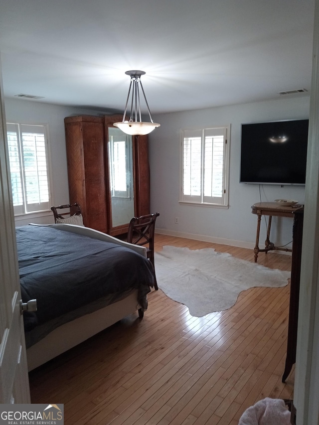 bedroom with hardwood / wood-style flooring