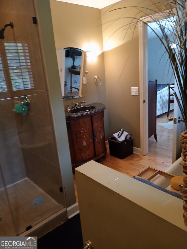 bathroom with vanity, hardwood / wood-style floors, and walk in shower