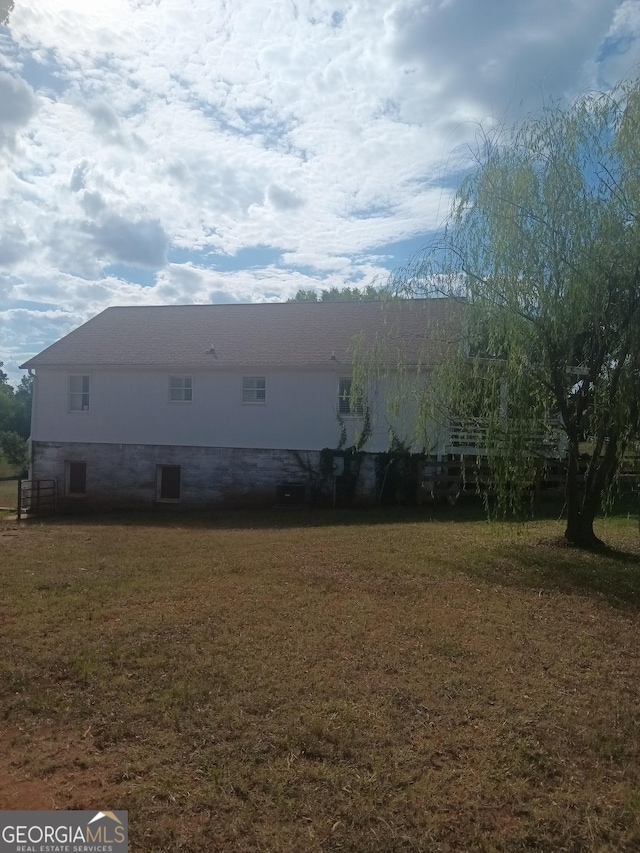 view of side of home featuring a yard