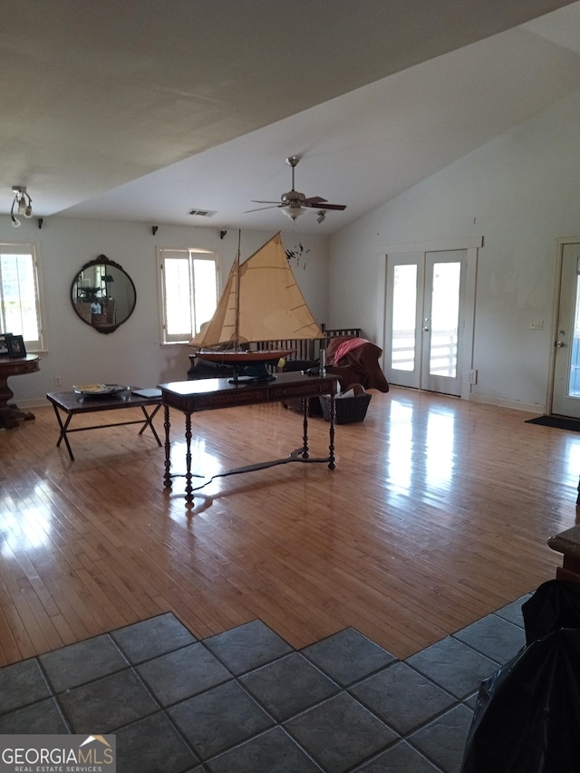 recreation room featuring ceiling fan, lofted ceiling, wood-type flooring, and french doors