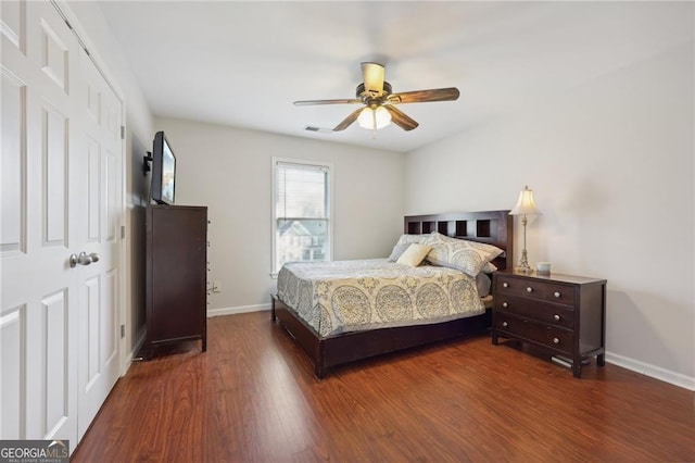 bedroom with ceiling fan and dark hardwood / wood-style flooring