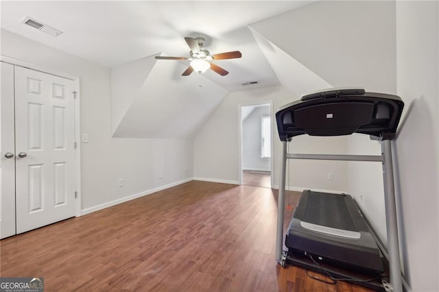 exercise area featuring hardwood / wood-style floors, vaulted ceiling, and ceiling fan