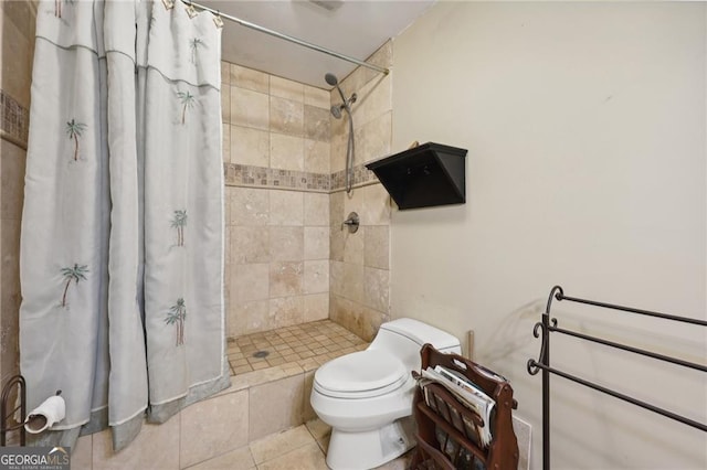 bathroom with tile patterned flooring, toilet, and walk in shower