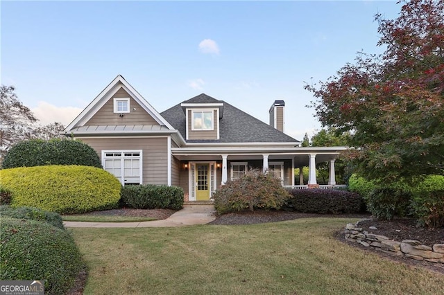 view of front of home featuring covered porch and a front lawn