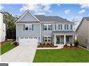 view of front of house with a garage and a front lawn