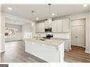 kitchen with white cabinetry and pendant lighting